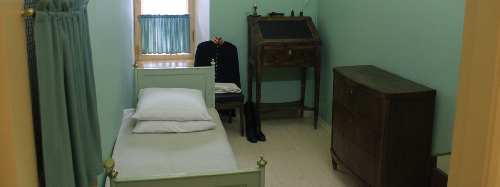 Келья в Царскосельском лицее в Пушкине: небольшая комната лицеиста с кроватью, столом и комодом